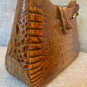 This is a beautiful embossed leather Brahmin saddle bag in perfect condition.